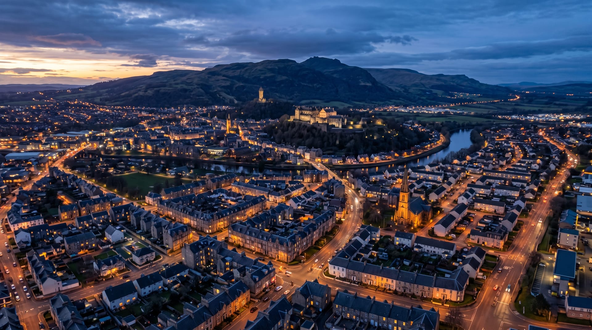 Central Scotland town at dusk with Stirling Castle and the Ochil hills